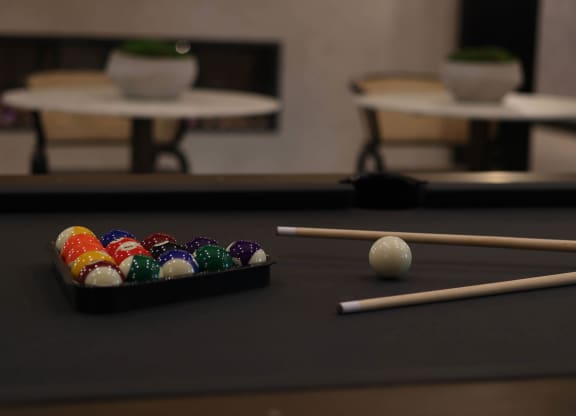 a pool table with balls and cues on it