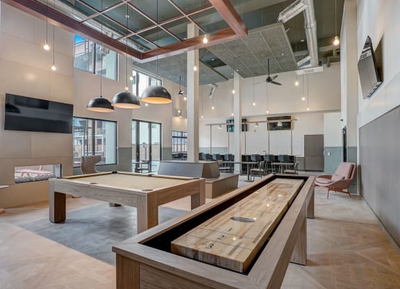a game room with a foosball table and ping pong