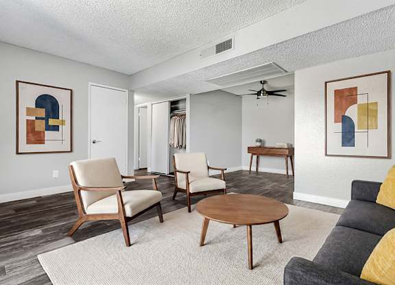 Model Living Room with Wood-Style Flooring at Accent on Rainbow Apartments located in Las Vegas, Nevada.