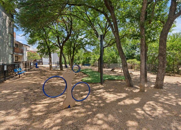 Community Dog Park with Agility Equipment at Woodcreek Apartments located in Arlington, TX.