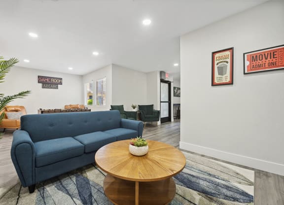 Community Clubhouse with Lounge Furniture and Game Tables at Villages at Metro Center Apartment located in Phoenix, AZ.