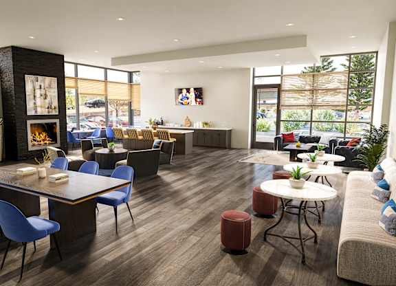 A modern living room with a dining area and a fireplace.