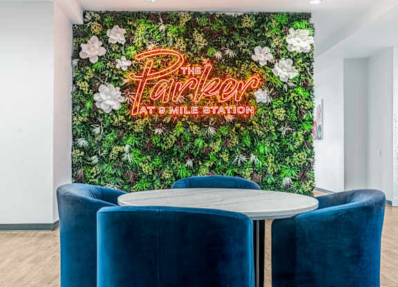 A green wall with flowers and the words