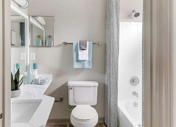 Model Bathroom with Wood-Style Flooring and Shower/Tub at Mirage on Kernan Apartments located in Jacksonville, FL.