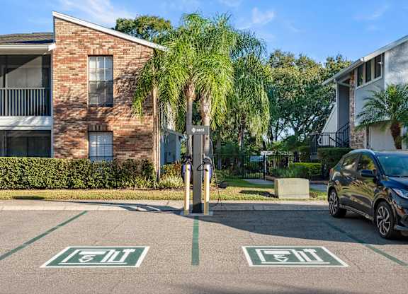 Apartment building exterior and EV charging station at Grand Pavilion Apartments in Tampa, FL