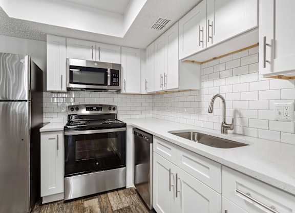 Model kitchen with appliances and cabinets at Haven at Water's Edge.