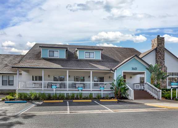 A white building with a blue trim and a sign that reads "3601" is shown.