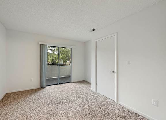 Model living room with sliding door at Rosehill Preserve in Orlando, FL