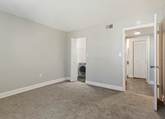 Model bedroom with carpet at Seven Lakes at Carrollwood in Tampa, Florida.