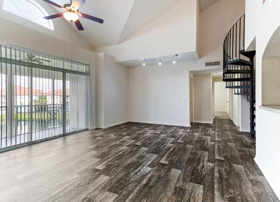 Model living room with vinyl hard-wood flooring and ceiling fan at Veranda at Westchase in Tampa, Florida.