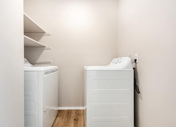 A white washing machine and dryer in a small laundry room.