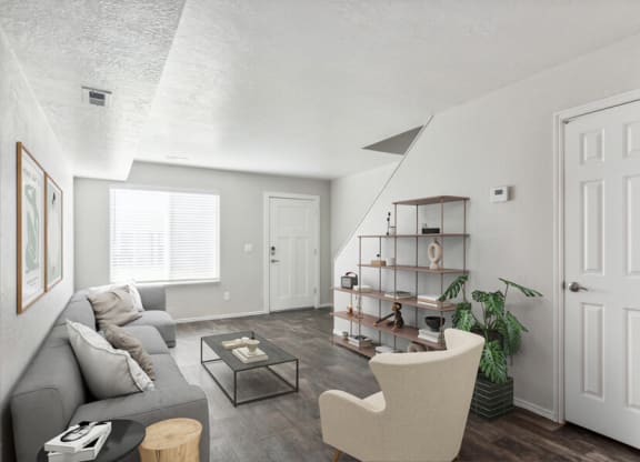 Model living room with a grey couch and a coffee table