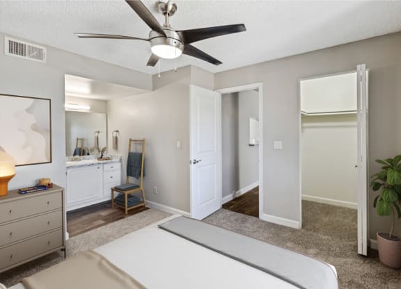 a bedroom with a bed and a ceiling fan