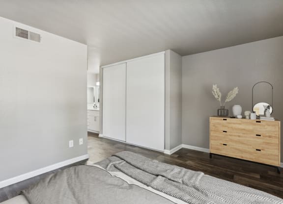 a bedroom with a bed and a dresser