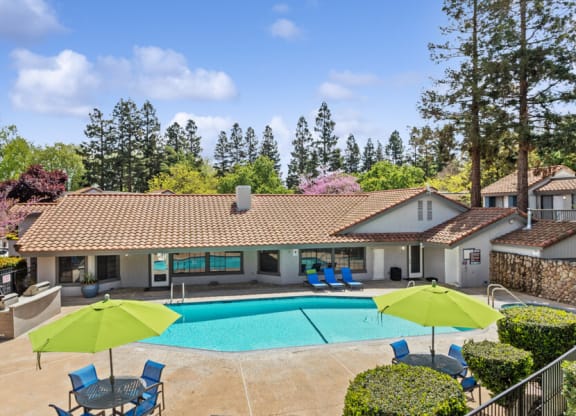 Clubhouse with a swimming pool in front of it