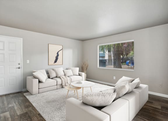 a living room with white couches and a coffee table
