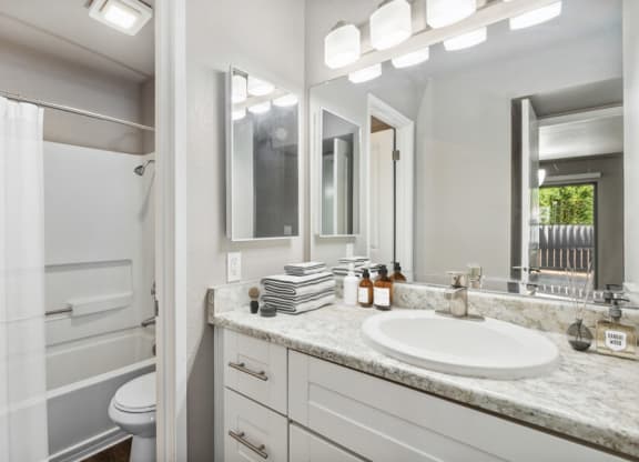 Model apartment bathroom with a sink and a toilet