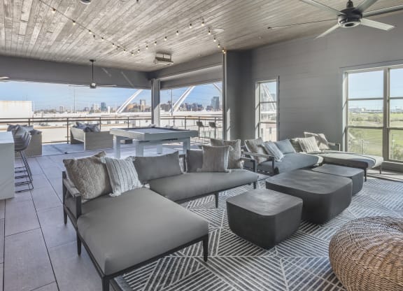 a living room with couches and a table and a view of a bridge