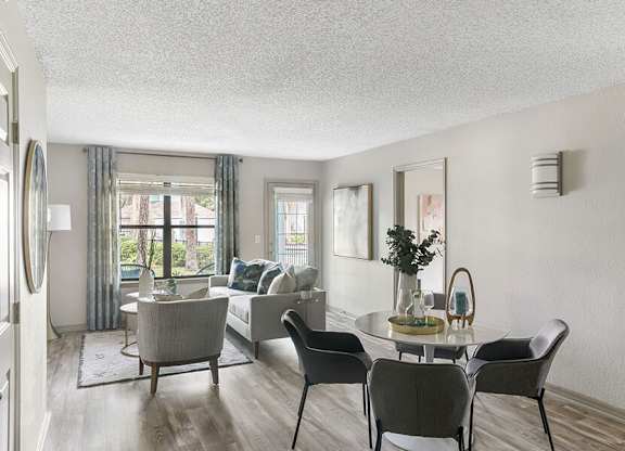 Model Living Room with Wood-Style Flooring at Mirage on Kernan Apartments located in Jacksonville, FL.