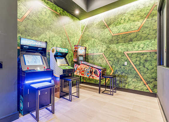 Community Clubhouse with Pinball Machine & other Arcade Gaming Systems at Ovation at Galatyn Park Apartments located in Richardson, TX.