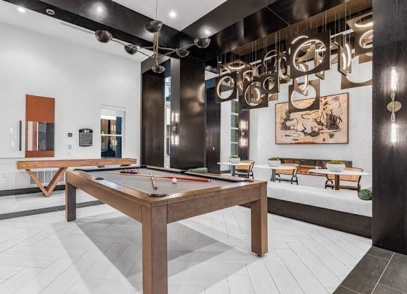 Community Clubhouse with Game Tables at Ovation at Galatyn Park Apartments located in Richardson, TX.
