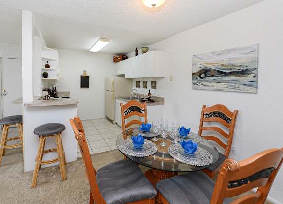 A dining room with a table set for two.
