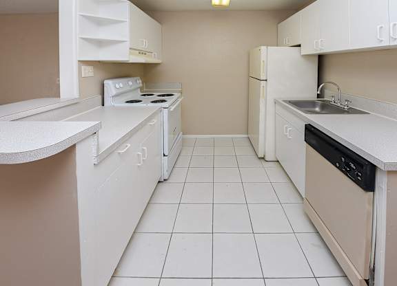 A small kitchen with white appliances and cabinets.