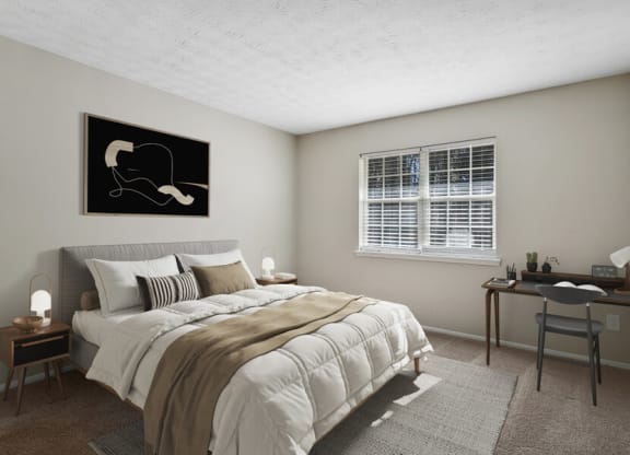 Model apartment bedroom with a bed and a desk and a window
