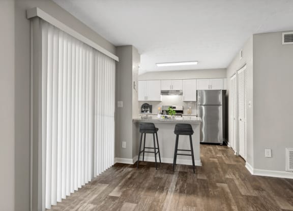 Model apartment kitchen with stainless steel appliances and a breakfast bar