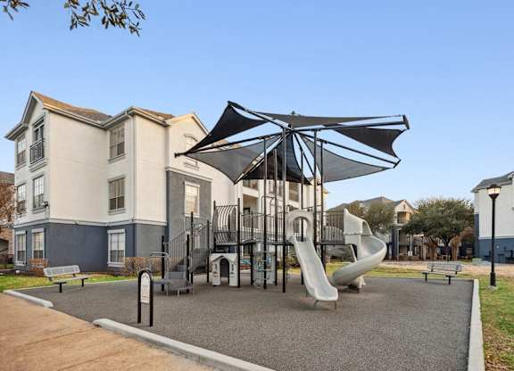 Community playground with sun cover at Park West Apartments in Houston, Texas