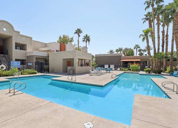 Community Swimming Pool with Pool Furniture at Helix Apartments located in Las Vegas, NV.
