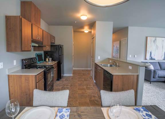A kitchen with a table set for two.