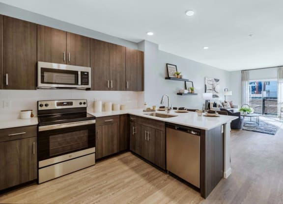 Model kitchen with stainless steel appliances at Glen 91 Apartments in Glendale, AZ