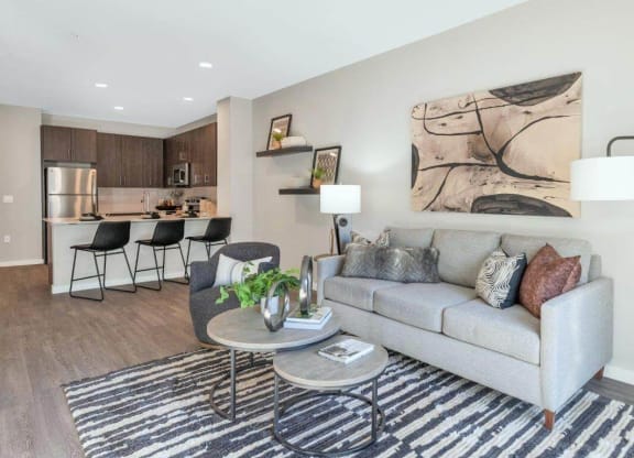 Model living room with couch at Glen 91 Apartments in Glendale, AZ
