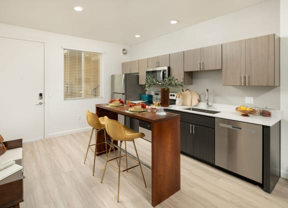 a kitchen with a large island with a breakfast bar