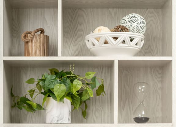 a bookcase with books and decorations on it