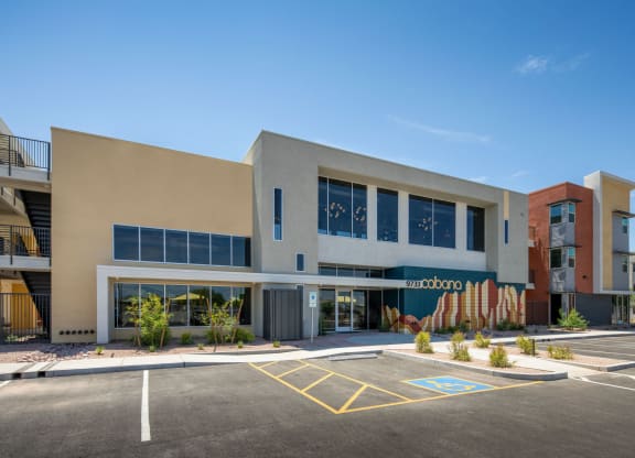 a large building with a parking lot in front of it
