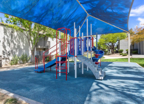 a playground with a blue and red slide