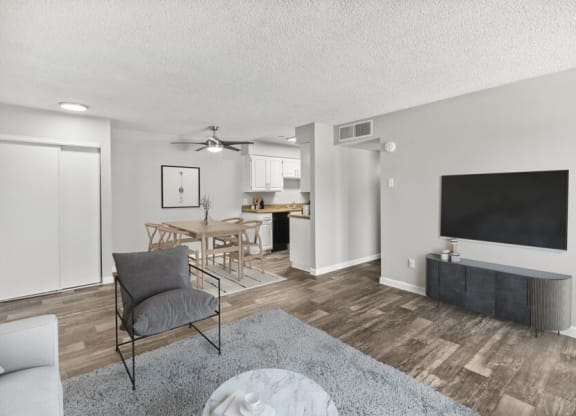 Model apartment living room with a couch a coffee table and a flat screen tv