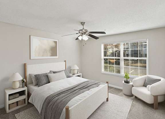 Model Bedroom with Carpet and Window View at Shadow Ridge Apartments in Riverdale, GA.