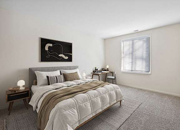 Apartments for Rent in Silver Spring, MD - Spring Parc - Bright Bedroom With Upholstered Bed, Neutral Bedding, Side Tables, Desk Nook, And Wide Window With Blinds Over Plush Carpet