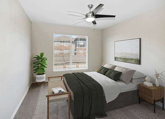 Three-Bedroom Apartments in Garland, TX - The Belmont at Duck Creek - A Bedroom With A Ceiling Fan, Window With Blinds, Nightstand Decor, Wall Art, And Potted Plant.