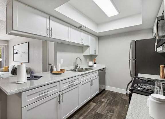 a kitchen with white cabinets and stainless steel appliances