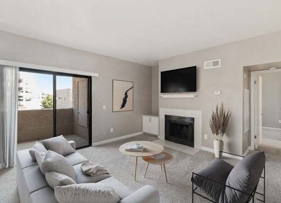 Model living room with fireplace and private patio