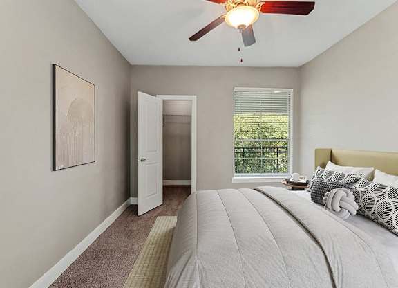 Model Bedroom with Carpet and Walk In Closet at Park West Apartments located in Houston, TX.