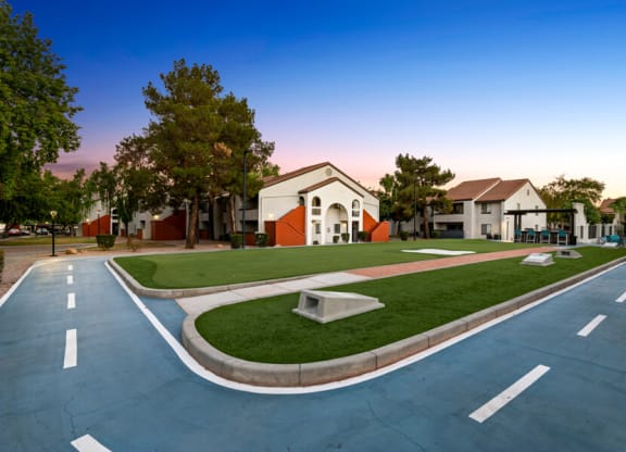an empty parking lot with a building in the background at Lore South Mountain, Phoenix, 85044