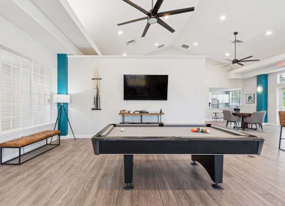 Resident lounge with TV and billiards table at Mirage on Kernan Apartments in Jacksonville, FL