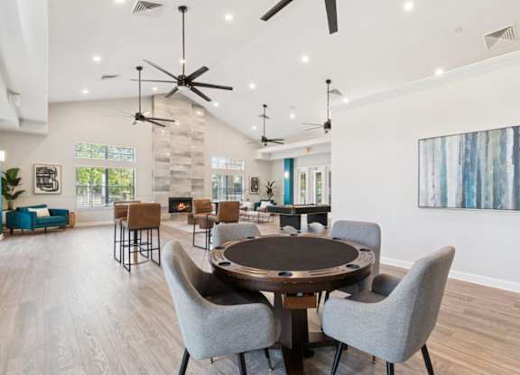 Community lounge with tables at Mirage on Kernan Apartments in Jacksonville, FL