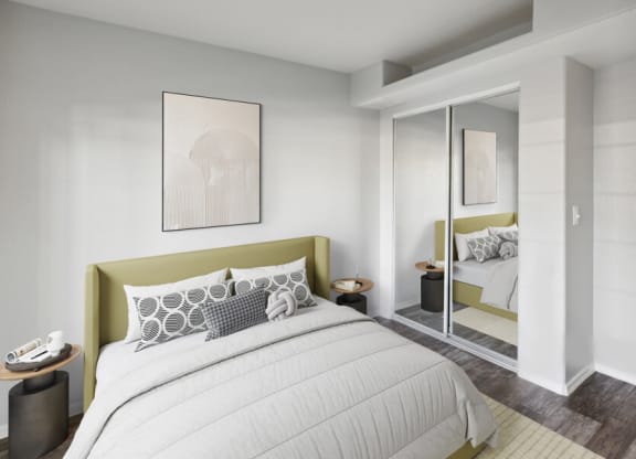 a bedroom with a large bed and a mirror