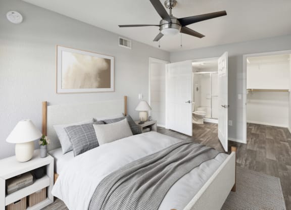 a bedroom with a ceiling fan and a bed
